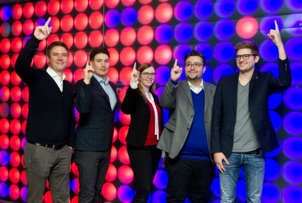 The 5 Founders of Holo-Light in Innsbruck pointing their fingers up